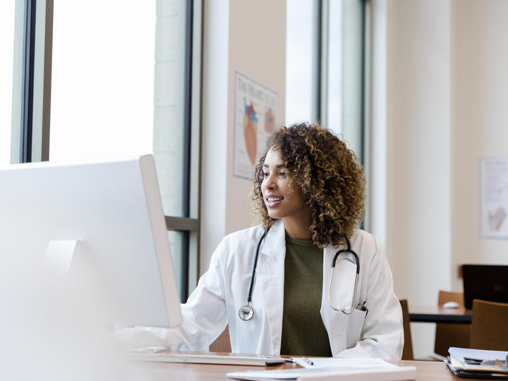 Physician at computer typing