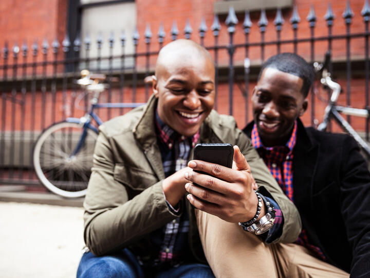 black males looking at phone