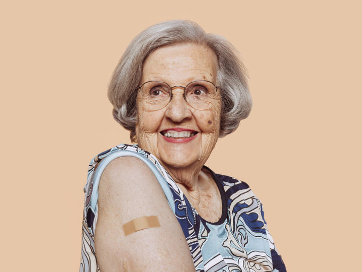 older woman with a vaccine bandage