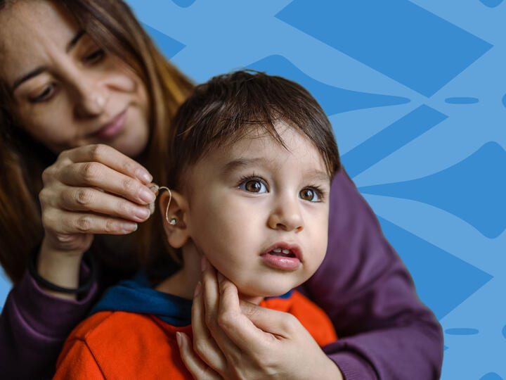 young boy with a hearing device