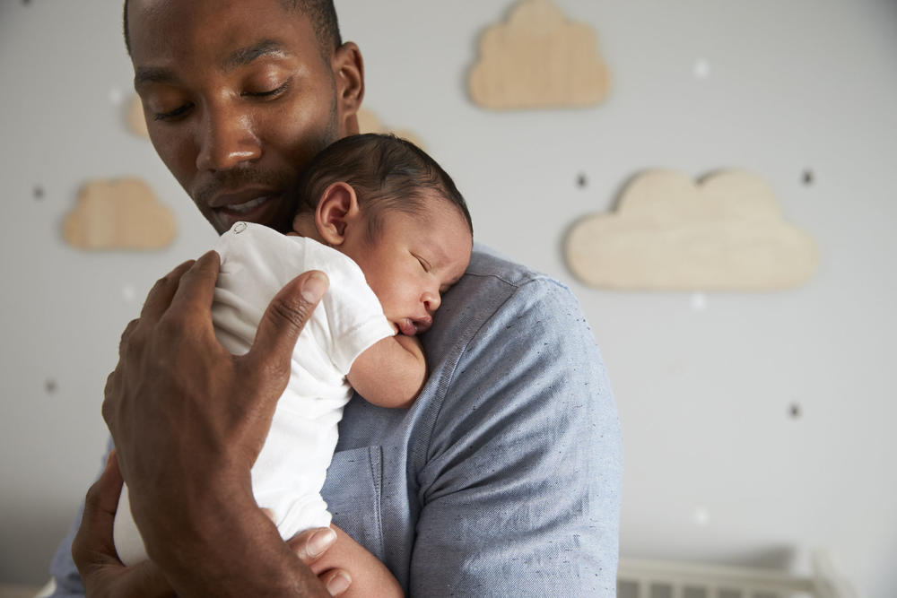 father holding infant