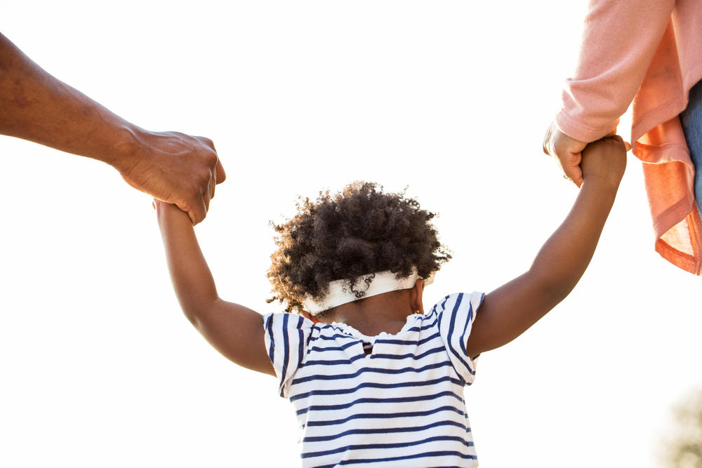 toddler holding parents hands