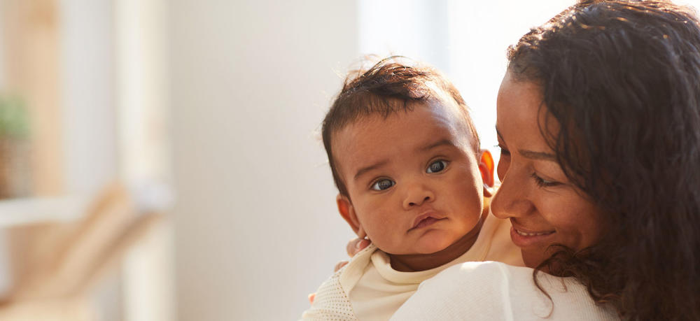 Baby looking over moms shoulder