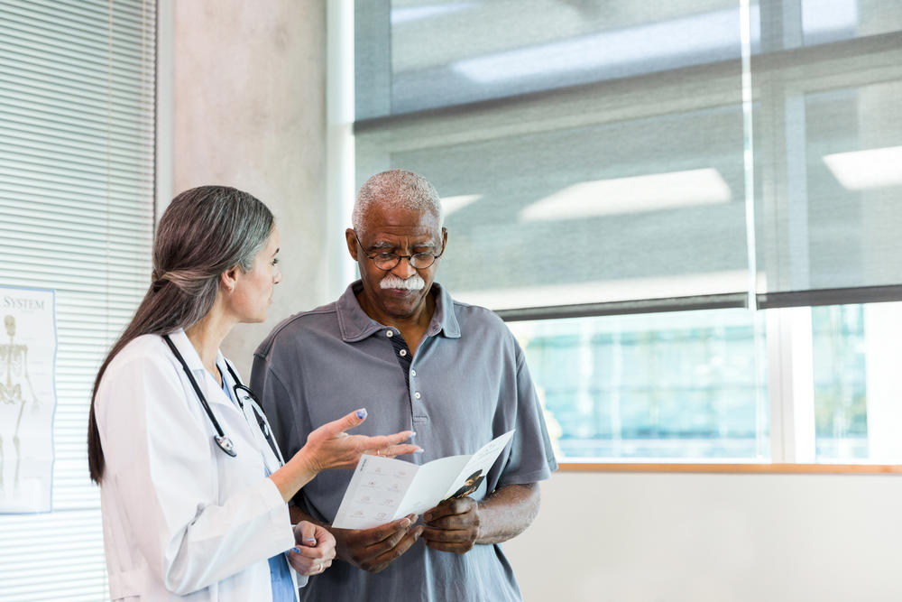 elderly patient talking with doctor