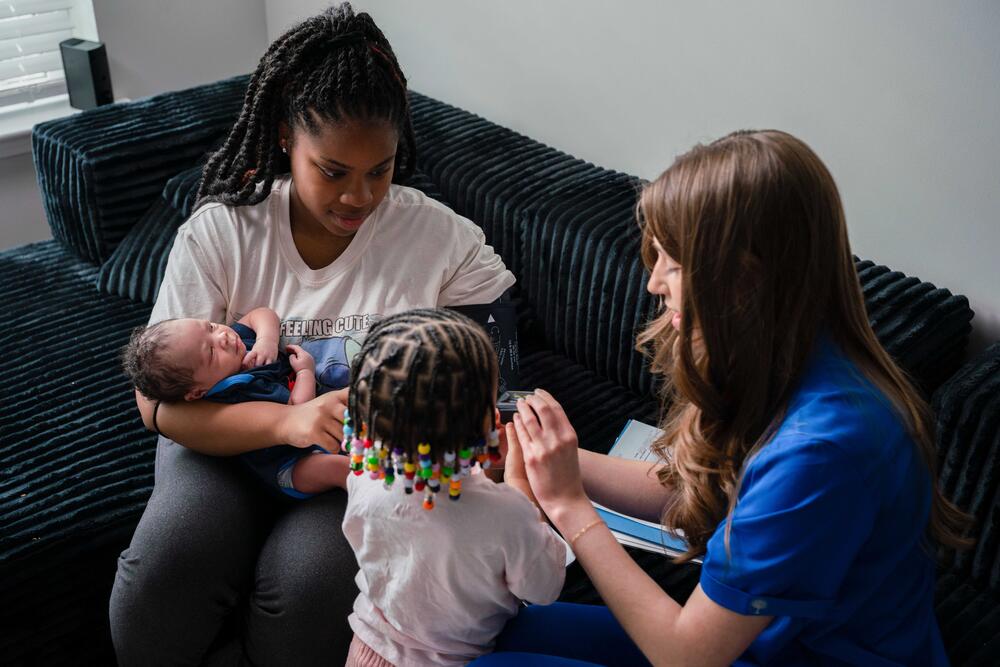 mother and children working with home visiting program staff