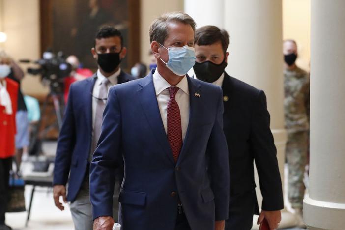 Kemp wearing a mask