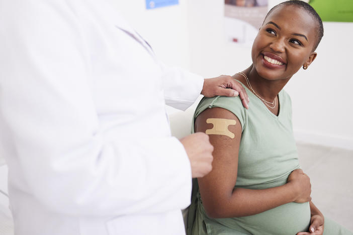 pregnant woman with a bandage after vaccine
