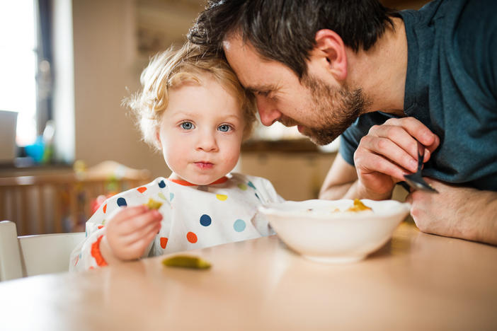 father and child eating