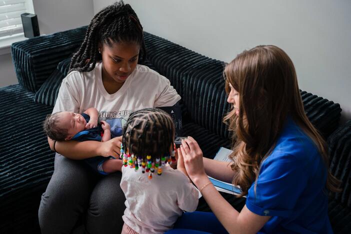 mother and children working with home visiting program staff